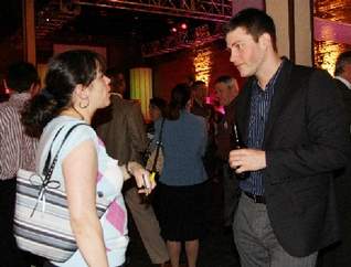 Michelle Lewis of Rochester, with Unlimited Coaching Solutions, visits with EPostmarks' Chris Bank of Rochester at the Digital Rochester gathering. The event featured a session on podcasts, led by Mike Saffran, associate director of university news services at Rochester Institute of Technology.